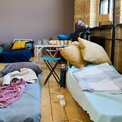 People staying in temporary housing like emergency shelters, transitional housing, or hotel rooms paid for by assistance programs.